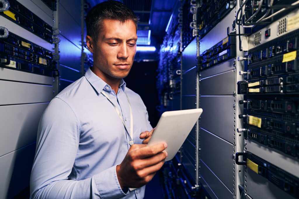 Focused data center system administrator verifying information